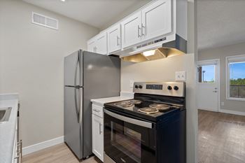 Kitchen with stainless steel appliances and a refrigerator